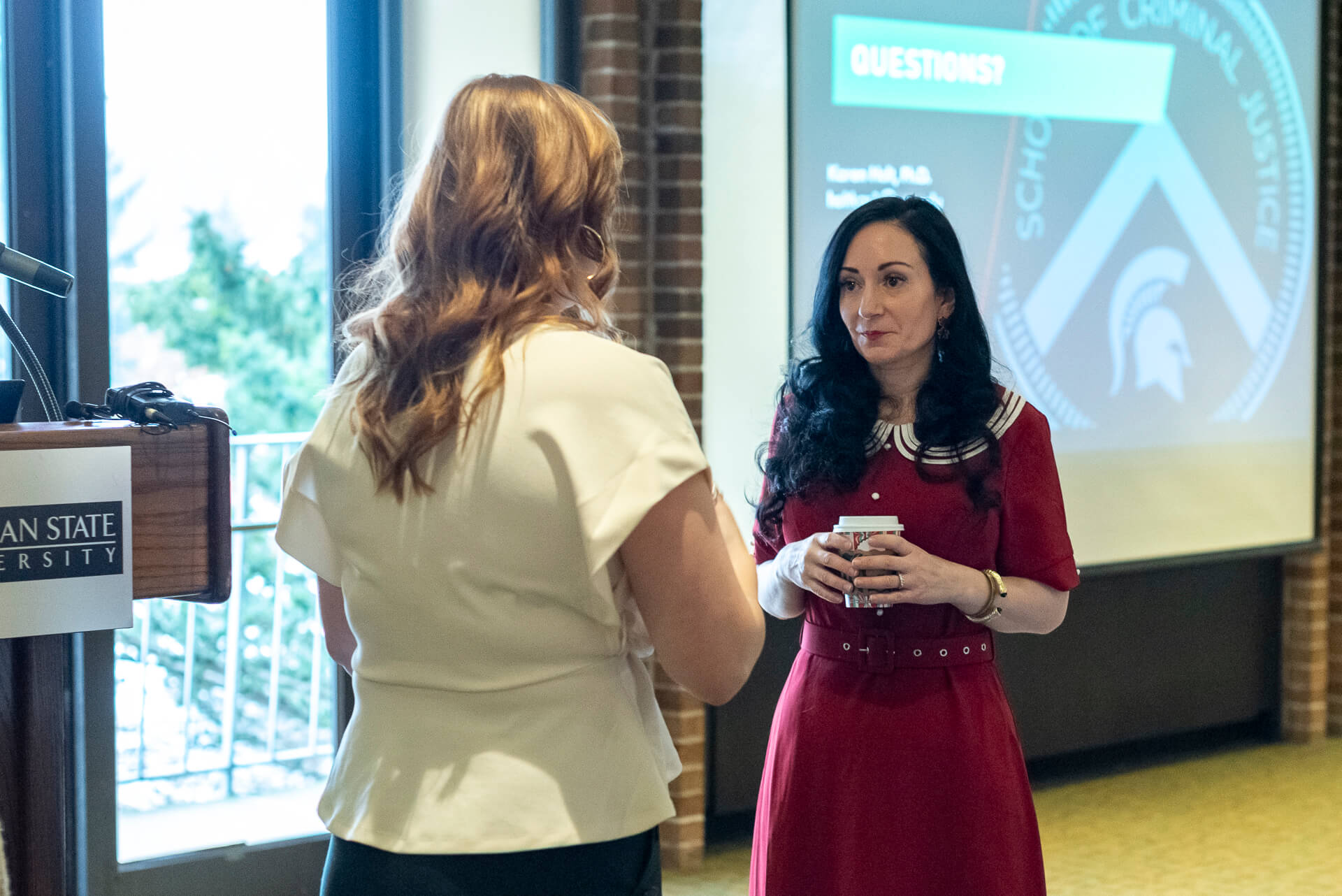 Photo of Dr. Karen Holt speaking with a participant at the first MSU Center for Cybercrime Investigation and Training event